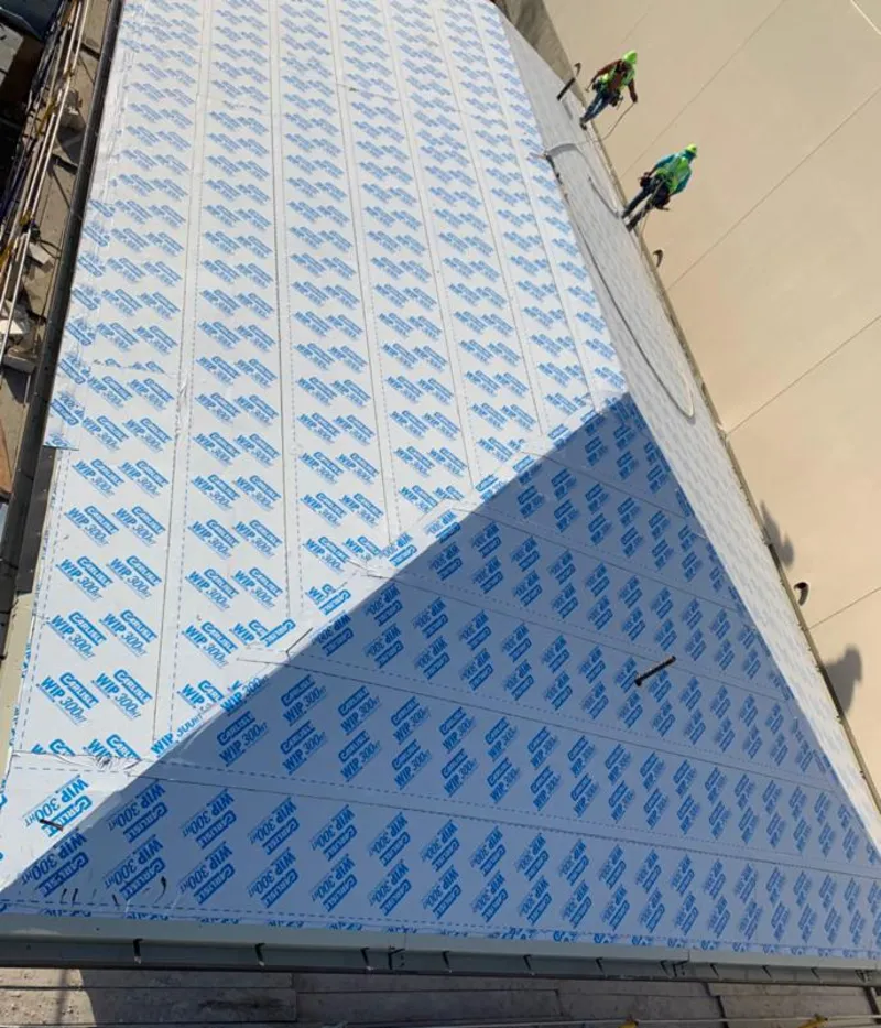 Professional roofers installing underlayment on a metal roof in Lake St. Louis